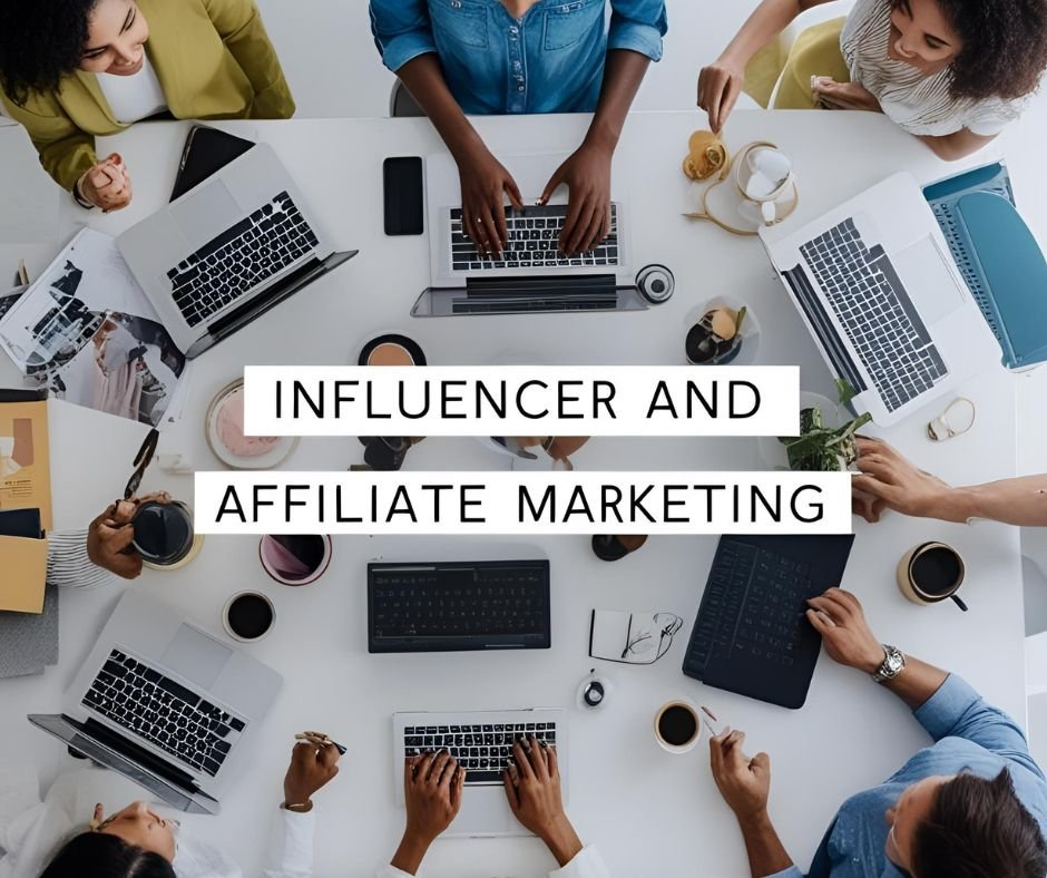 "A group of people sitting around a table with laptops, notebooks, and coffee cups, working on influencer and affiliate marketing."